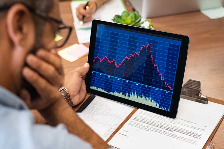 Businessman looking at the stock market on a tablet